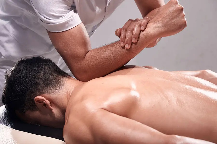 "Professional Thai massage therapist performing stretching techniques in Orange Spa Dubai."